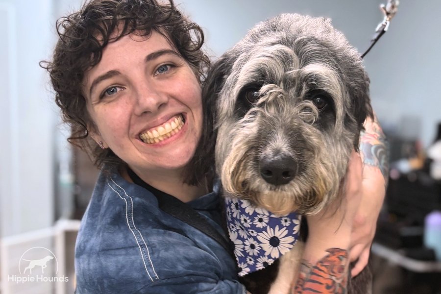 Photo of owner of Hippie Hounds in Lynnwood Wash, Amanda, and a gray doodle. The salon specializes in dog grooming for aggressive dog needs and is owned by professional groomers with over 21 years of experience.