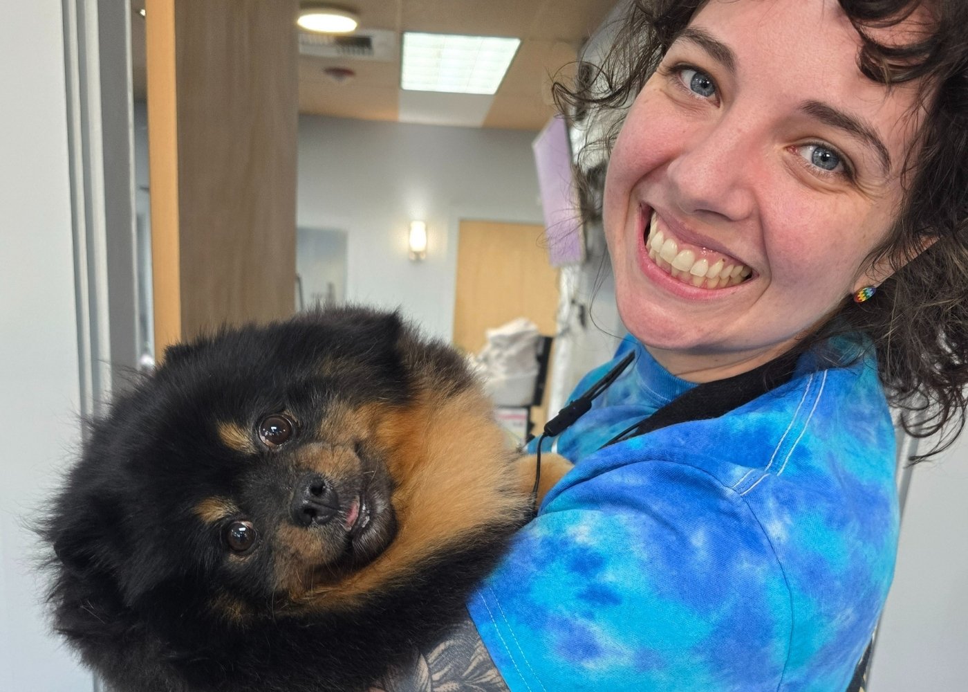 Amanda with a Pomeranian At Hippie Hounds, we care for every dog as if they were our own.